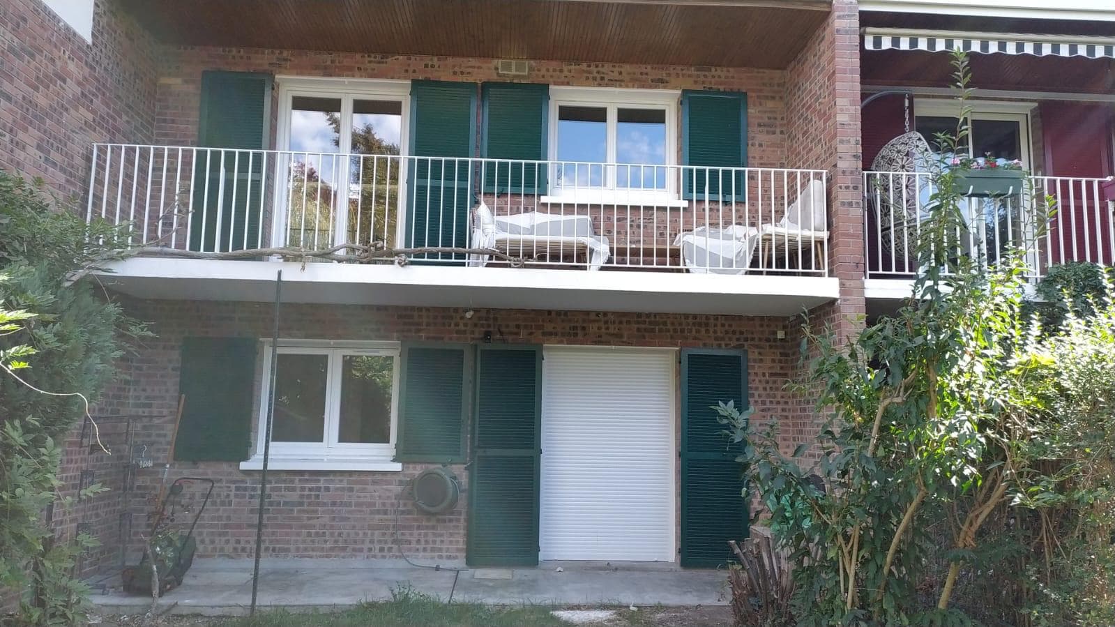 Garden-side façade with renovated green shutters