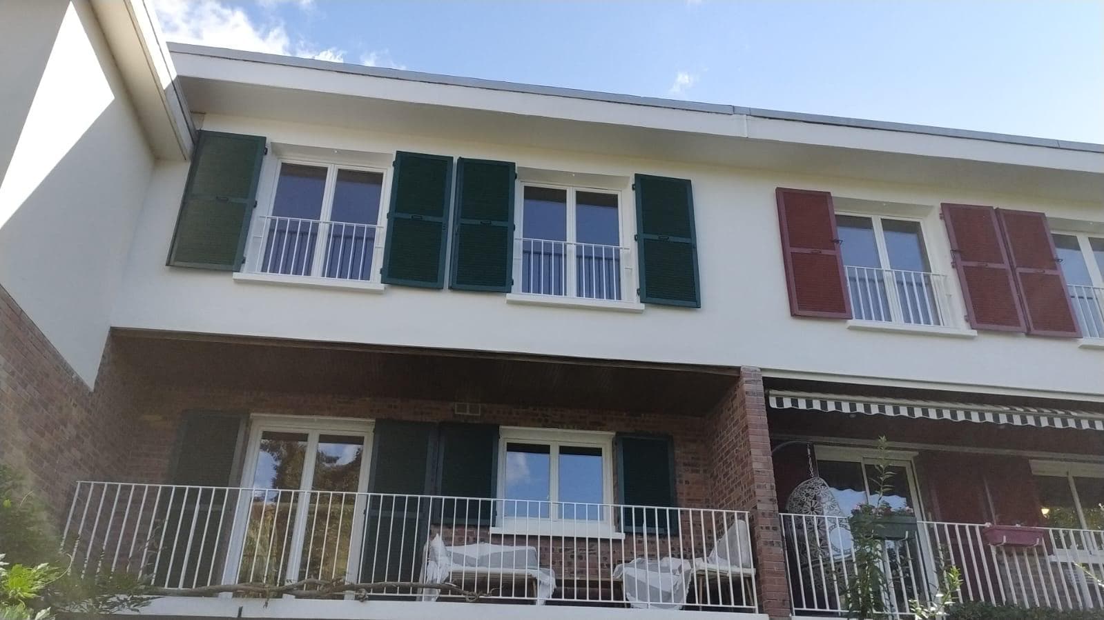 Renovated façade with green shutters